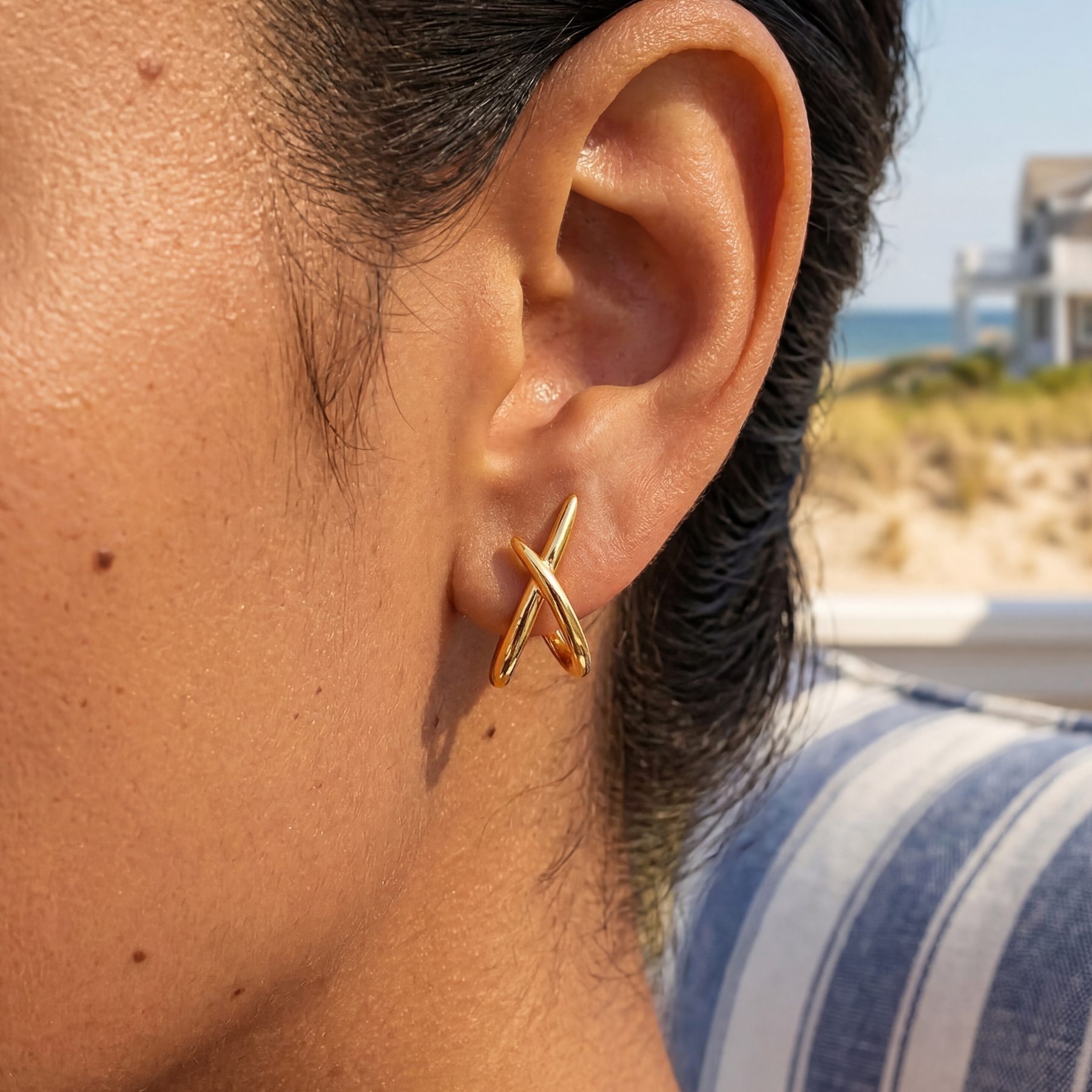 MUMREUES gold X earrings worn on model